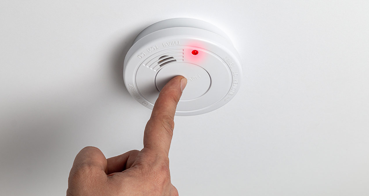 Testing home smoke alarm detector. Stay home safe. Home control