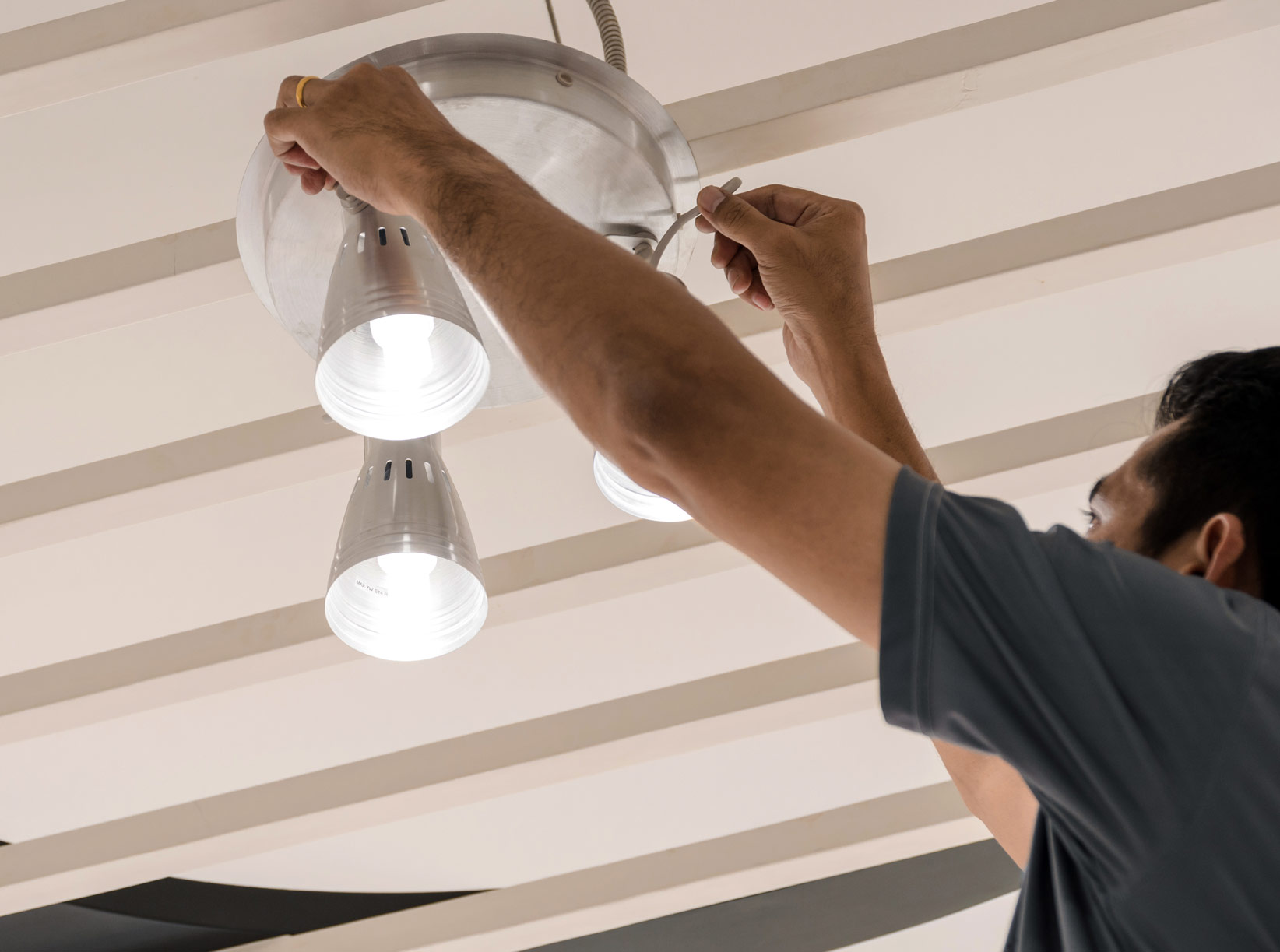 Electrical engineers are installing ceiling lamps in the hallway